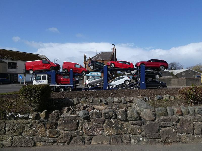 A loaded car transporter on a road